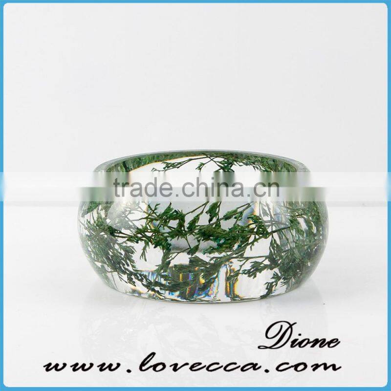 Pine needles inside transparent clear acrylic bangle stand