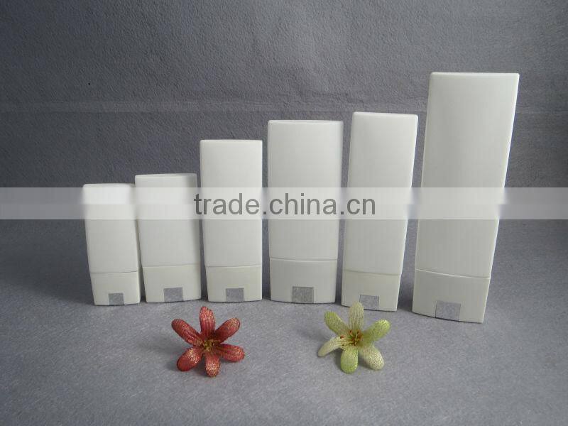 light yellow plastic cosmetic bottle with black cap