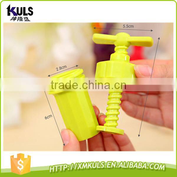 Small plastic tool for mashing garlic