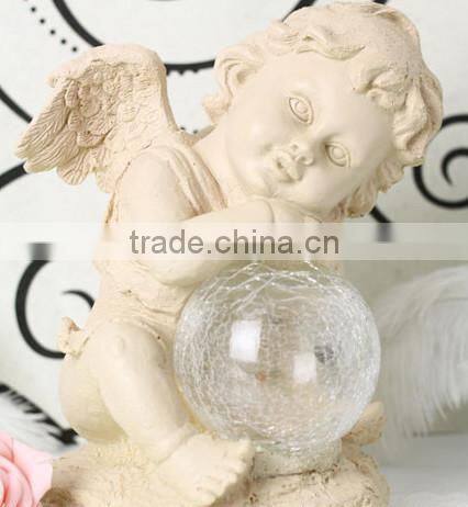 Resin solar lighting angle figurine holding a luminur glass globe garden ornamenet