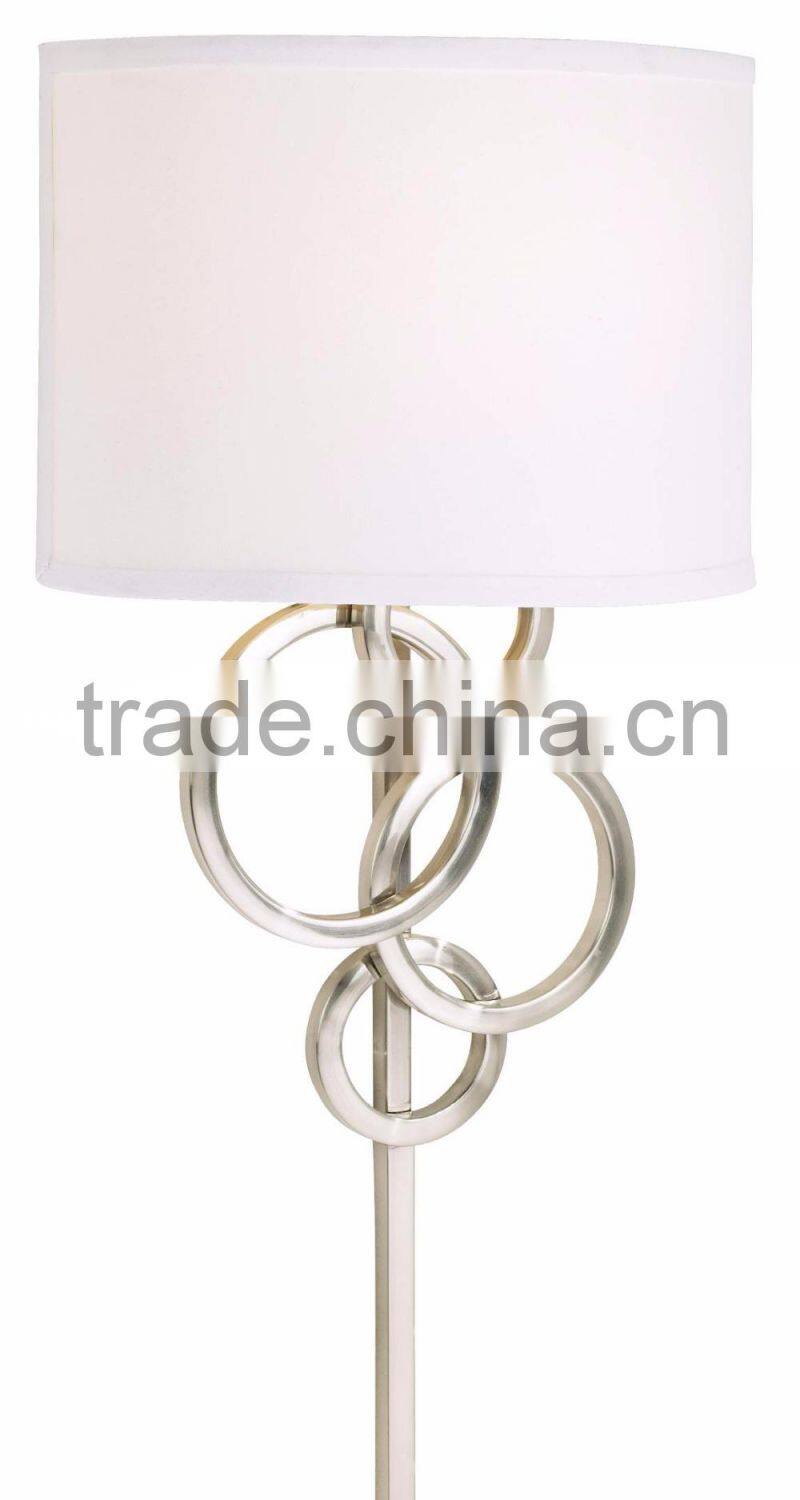 1017-1 sleek brushed steel finish raindrops falling on a calm body of water intertwining Circles Plug-In Wall Sconce