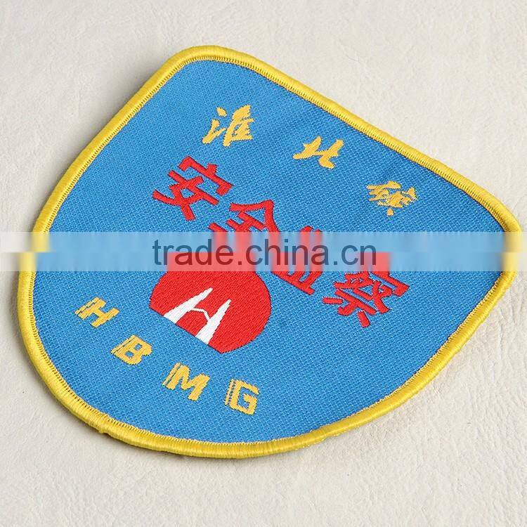 Woven badge with deep blue background for coal factory workwear