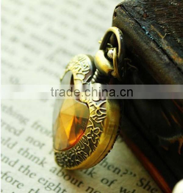 Cutting transparent glass heart shaped old pocket watch