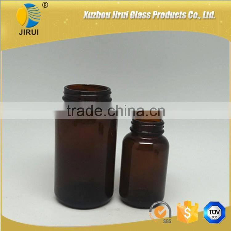 Amber vitamin pill glass bottle with lined black closure