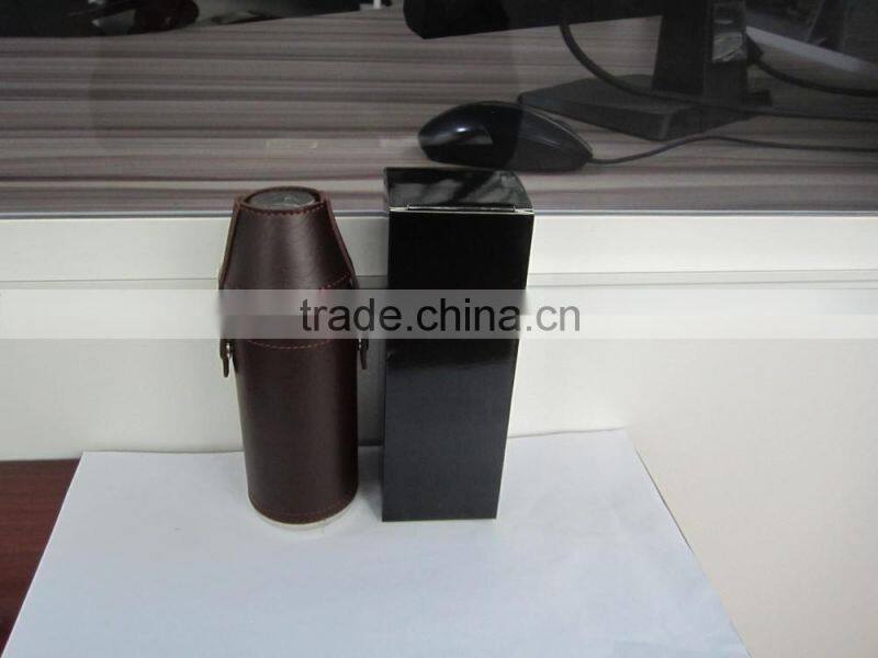 Cylindrical shape and suture and leather wrapped bottle and 2 glasses