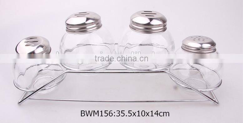 4pcs round glass spice jars with metal lid on a metal rack