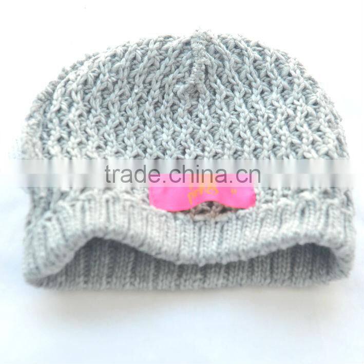 grey knit hat with crochet flower for girls