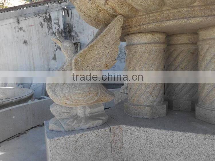 Yellow granite column water fountain with swan