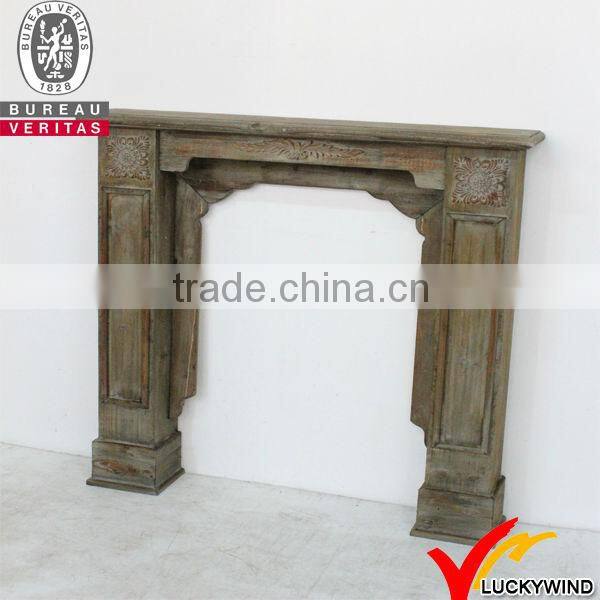White antique wooden fireplace mantel
