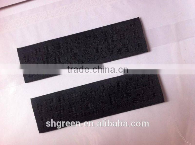 straight cut black background black logo woven label