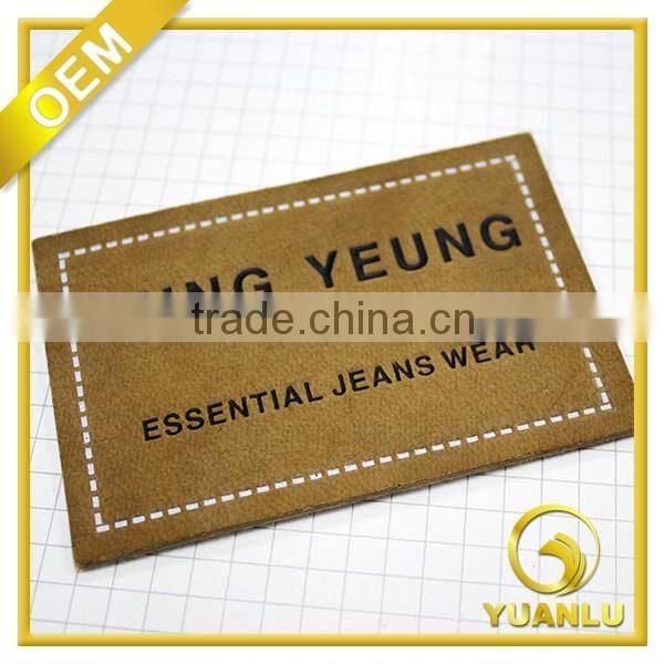Embossed leather label essential jeans label