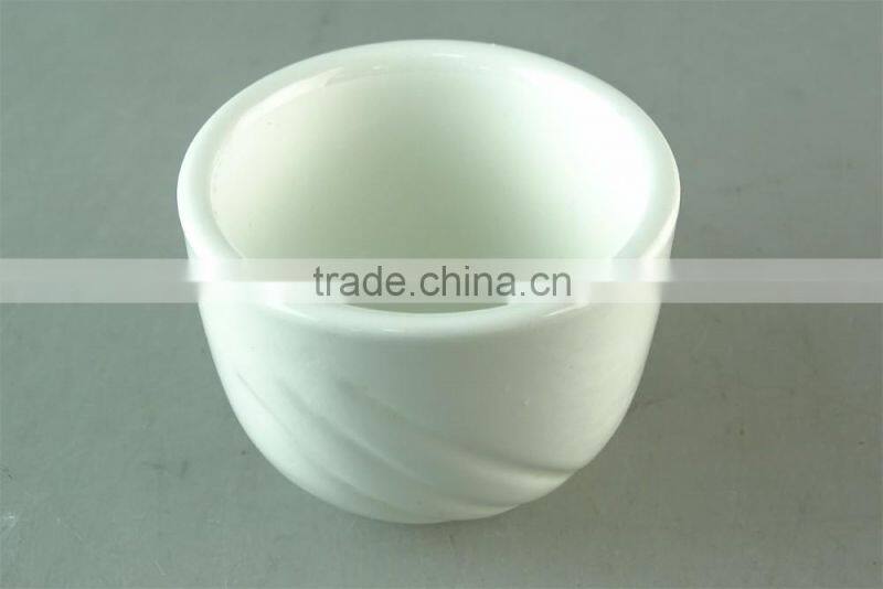 white porcelain cup with embossed wave design
