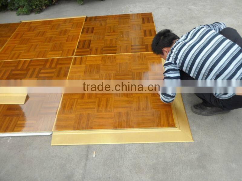 Natural teak wooden dance floor with gold anodized aluminum trim