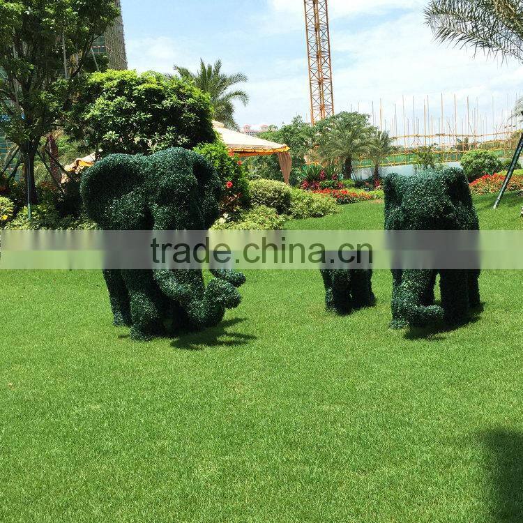 Green grass elephant statue
