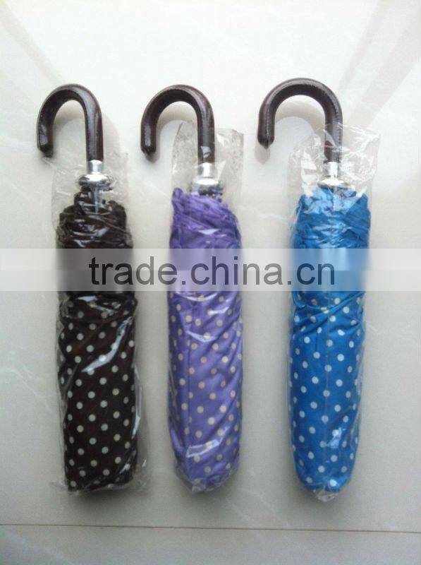 Beautiful lady folding umbrella