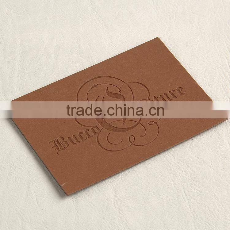 Imitation leather tag with embossed logo for young man pipestem pants
