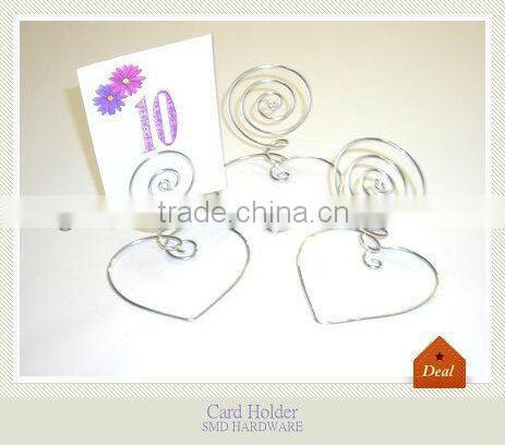 Wrought iron swirl heart card holder on table