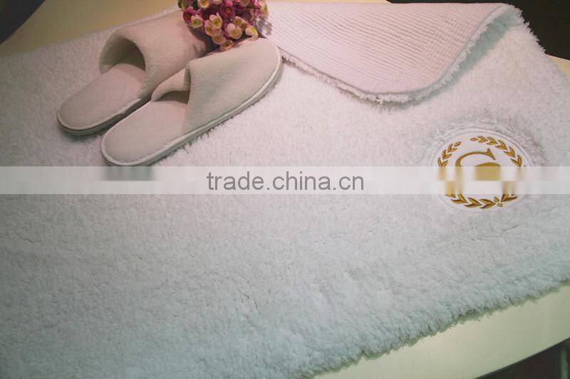 cotton bath rug hand tuffted with embroidered logo