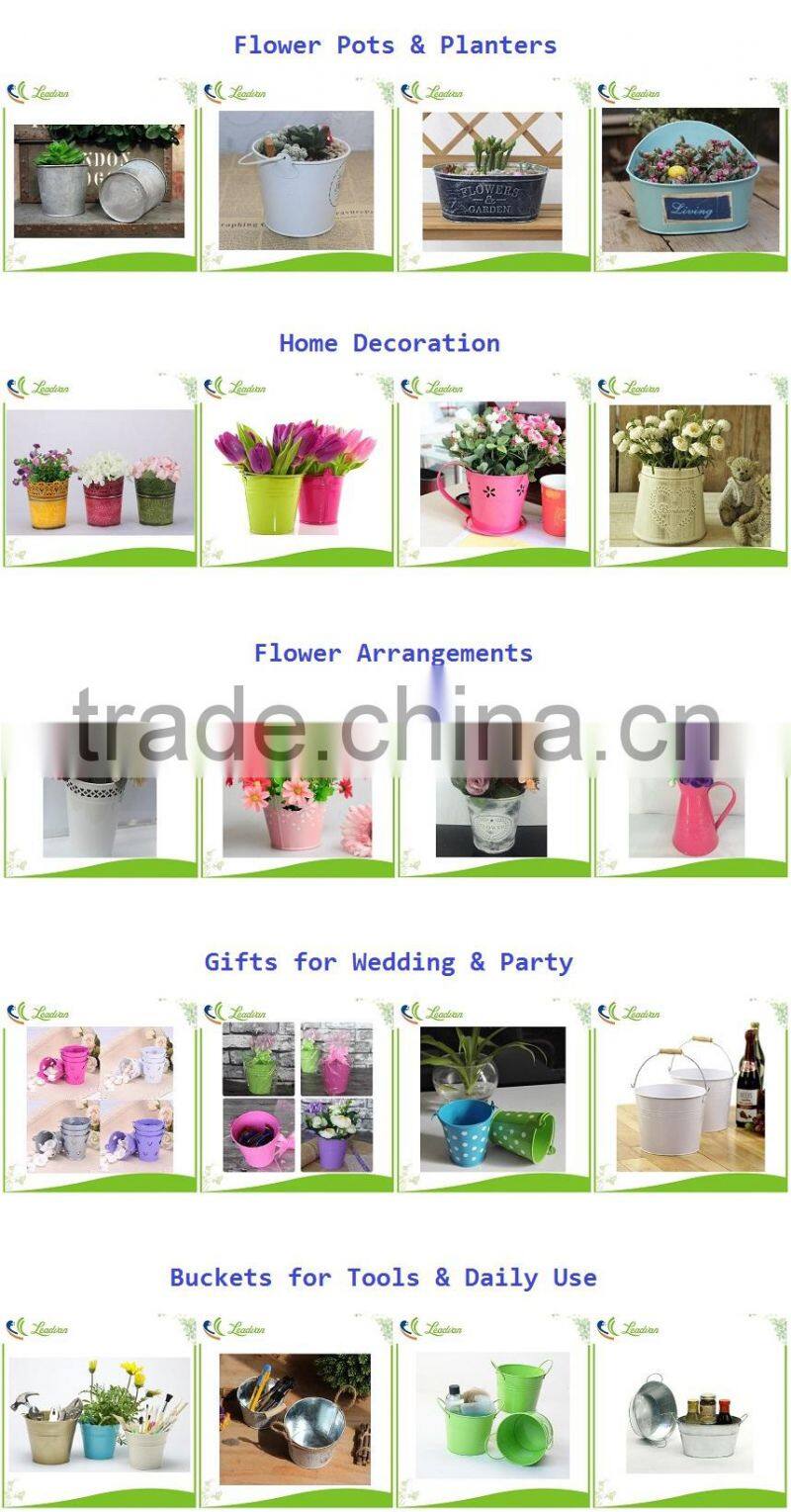 Round and oval shaped white metal planters for outdoor and garden decoration