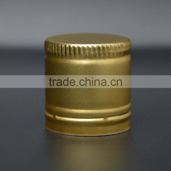 Golden aluminium caps for wine glass bottles