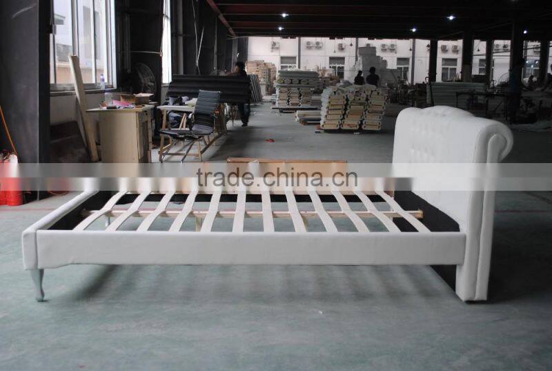 White leather bed with tufted headboard