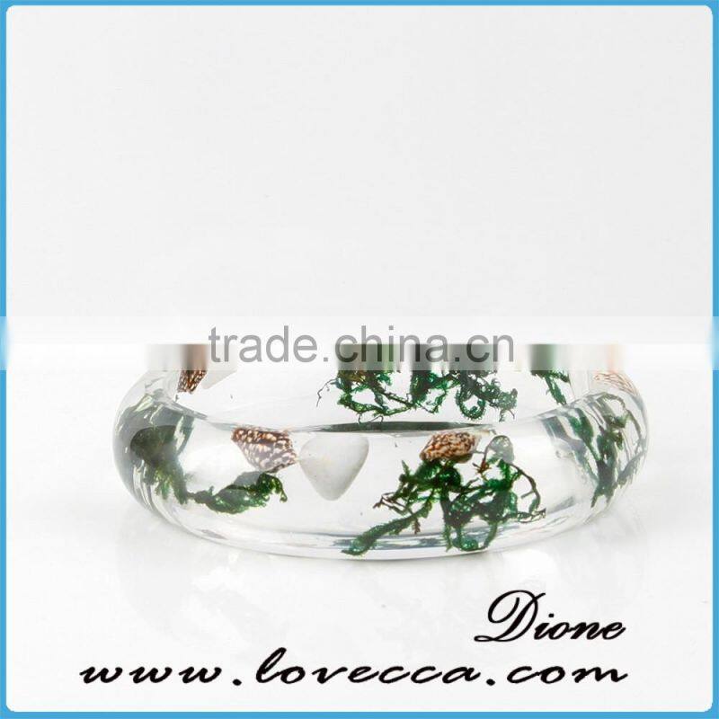 Pine needles inside transparent clear acrylic bangle stand