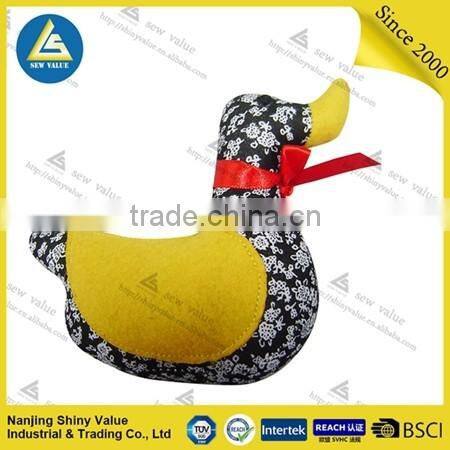 decorative black&white duck shape pin cushions with yellow wings for sewing work