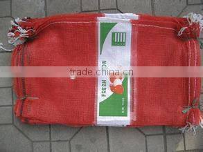 green mesh bag packing onion potato