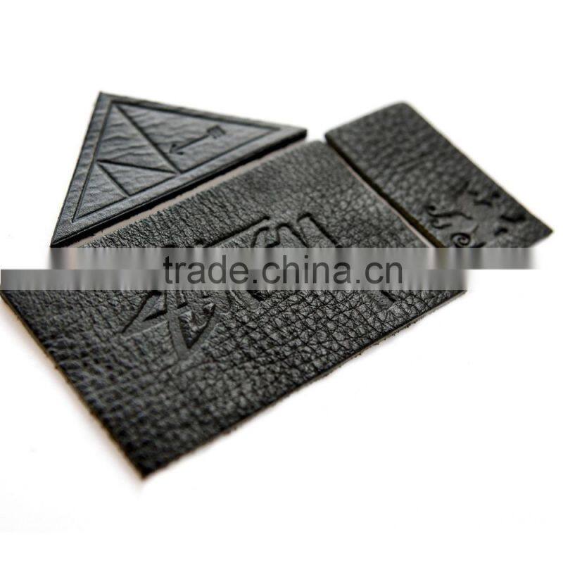 Custom & design embossed leather label for garment in dongguan