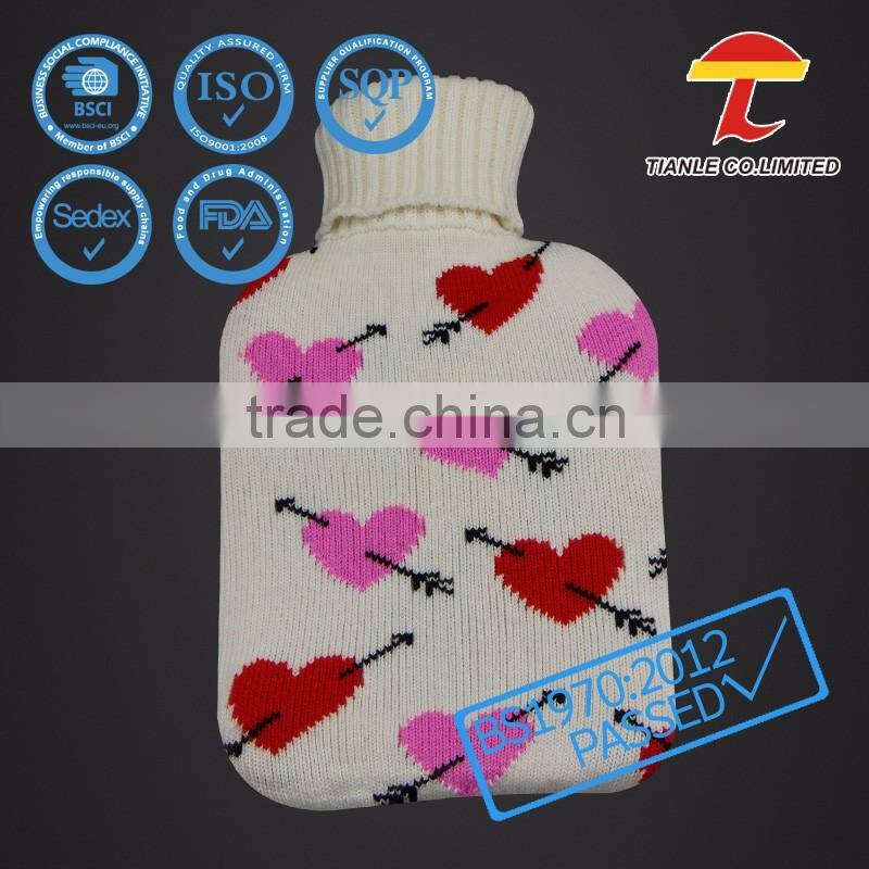 Natural rubber hot water bottle with Cupid's arrow design knitted cover