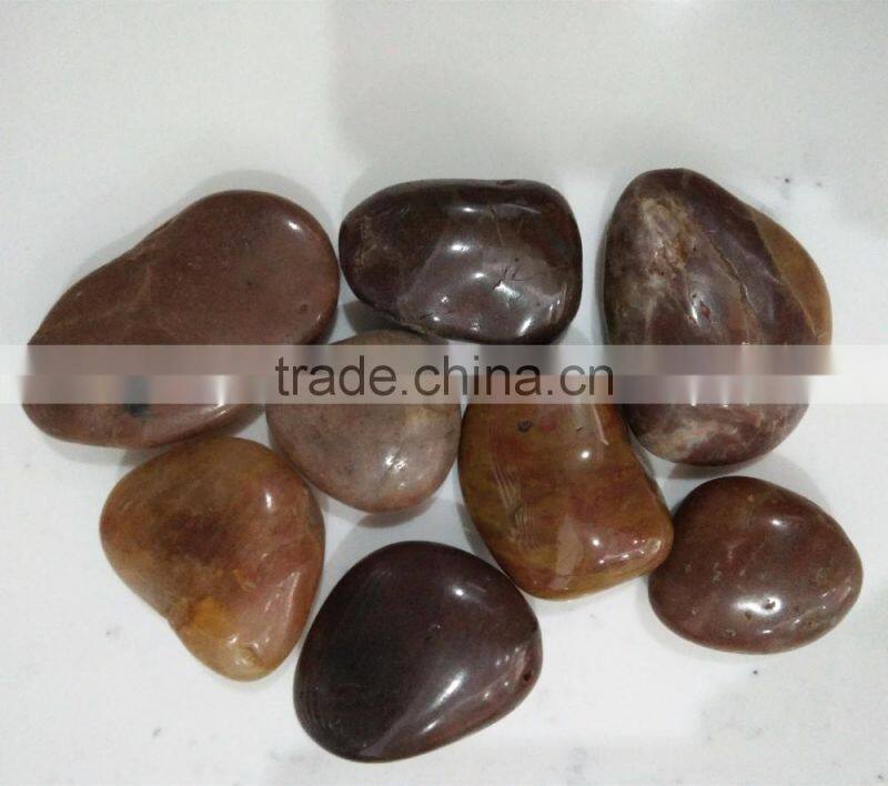 Polished red pebble stone and cobblestone on promotion