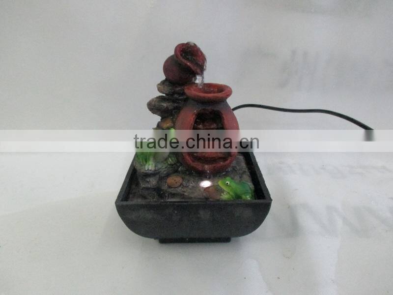 Resin table water fountain with 2 frogs on it