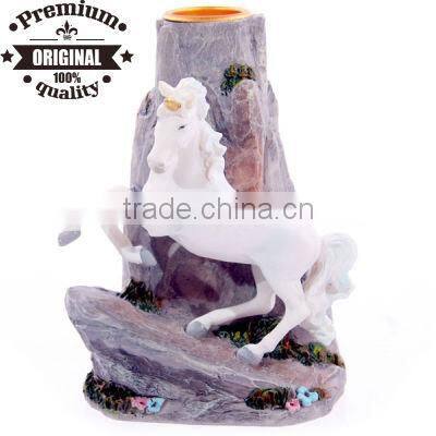 resin unicorn on rock candle stick holder