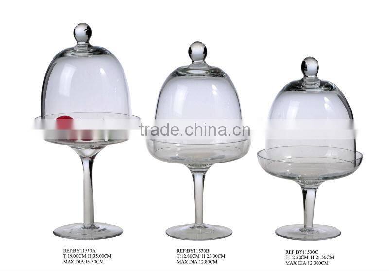 clear glass cake cover with white wood stand