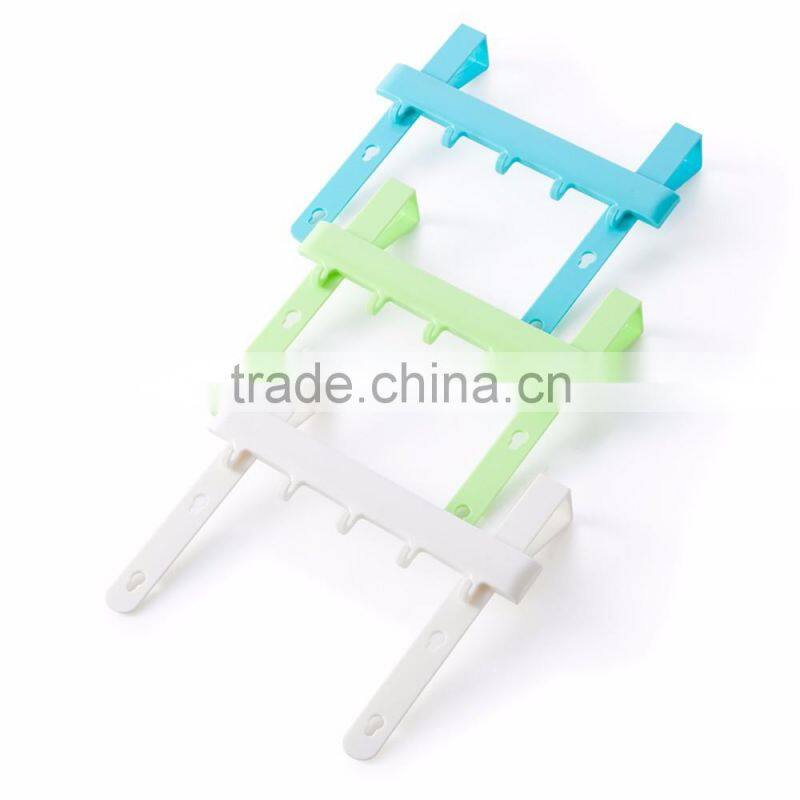 Multipurposed pothook behind the kitchen door