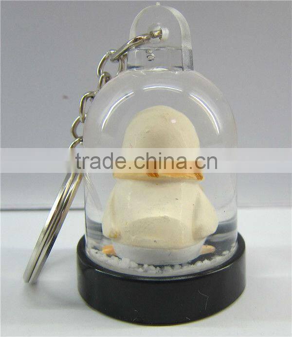 Plastic snow globe penguin key chain