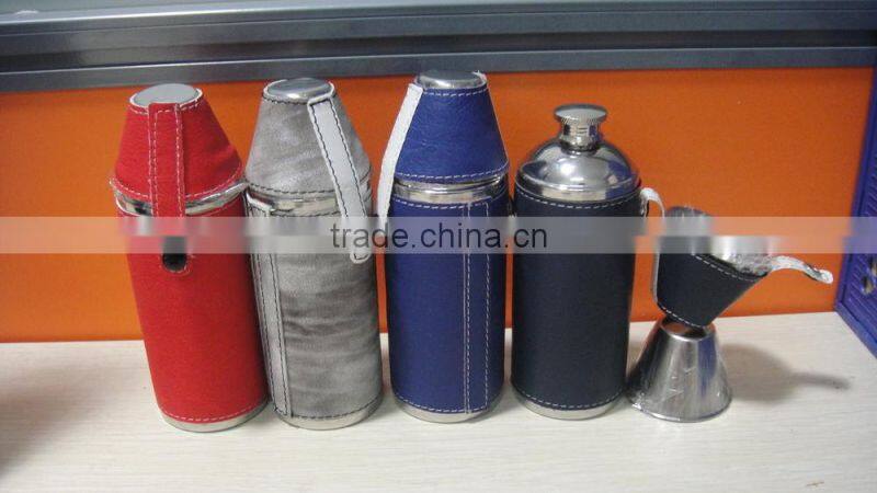 Cylindrical shape and suture and leather wrapped bottle and 2 glasses