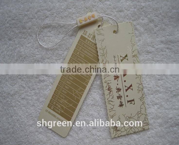 Die-cut paper swing tag with gold metal ballchain