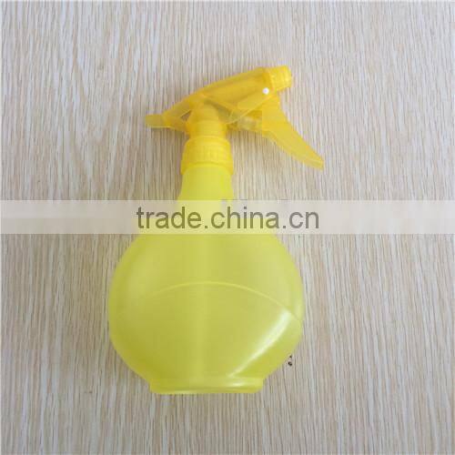 yellow transparent plastic garden spray bottle with trigger
