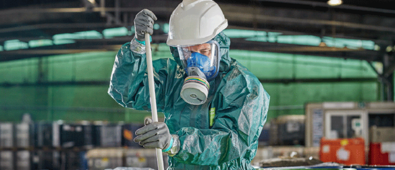 Protected worker in chemical work setting.png
