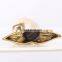 ceramic artwork of golden whale tail ornaments
