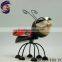 Decorating outdoor garden with folk art metal bee ornaments