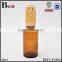 30ml round shoulder pharmaceutical amber glass serum bottle with gold press pump