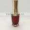 Red painted nail polish bottle with UV cap and shoulders