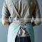 Custom blue cotton canvas kitchen apron with cross-back straps