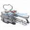Hand-held pneumatic strapping machine