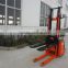 1.5 Ton Standing on Operated Battery Electric Straddle Stacker Lifter in Material Handing Equipment