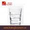 300ml clear glass cup with small bubbles at the bottom and embossed letter for drinking