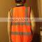 Orange high visibility safety vest with many pockets