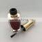 Red painted nail polish bottle with UV cap and shoulders